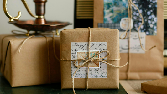 Brown wrapped packages with personalized details and twine wrapping show the final product of handmade gift ideas for friends.