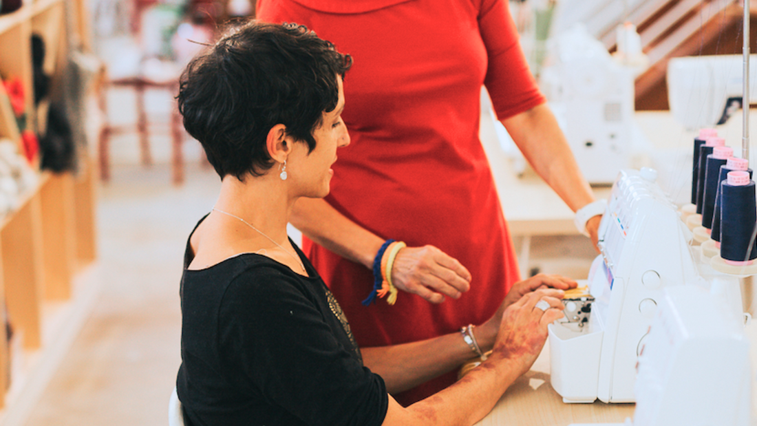 Two women learning how to sew at a sewing class in Columbus, OH